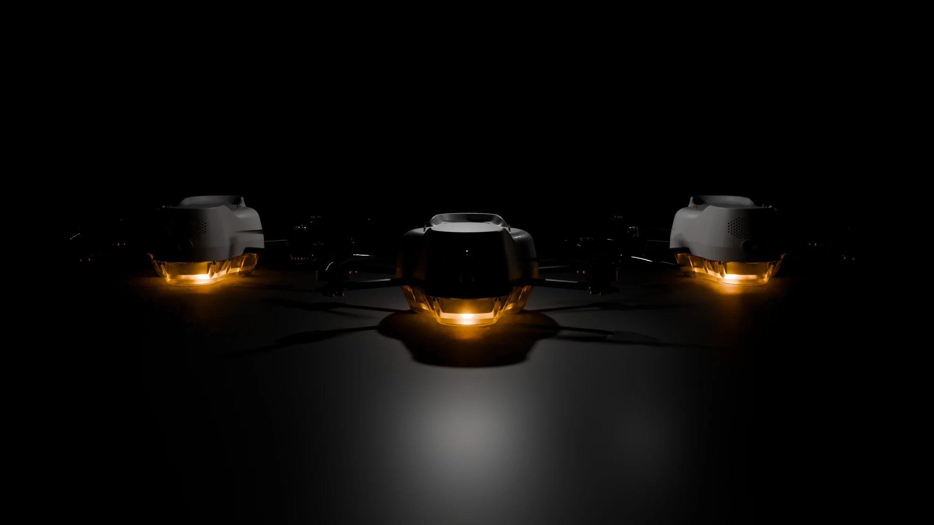 Three Spectra drones in the dark with glowing amber light modules
